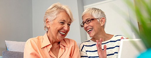 Image of two senior women sharing a laugh together